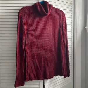 Cozy, chunky red sweater with side slits..